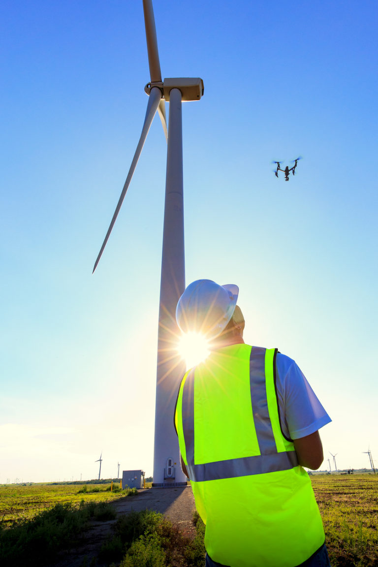 Drone Pilot Operating UAV During Wind Turbine Inspection Custom Weather